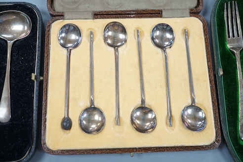 Three assorted silver cased sets, including coffee spoons, christening trio and spoon and pusher.